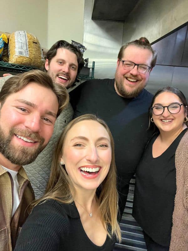 Photo of 5 people smiling after a chefs table experience. A happy couple, the restaurant manager, the chef's assistant and the chef
