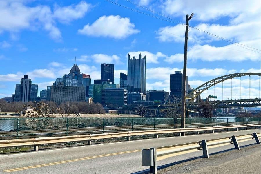 A view of the Pittsburgh skyline with a large bridge on the right side