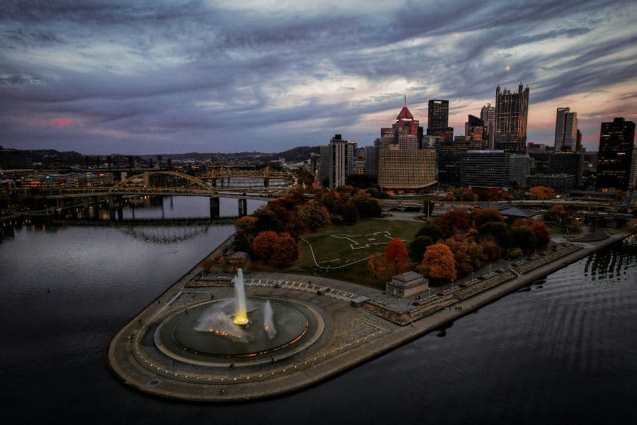 Point State park in Pittsburgh PA taken by photographer Jocelyn Allen. Photo was taken at dusk and shows the skyline and Point State Park's large water fountain feature